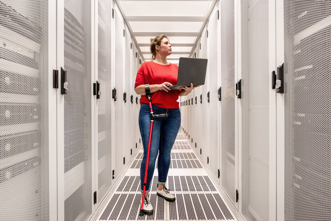 Woman with a damaged hip joint working in data centre